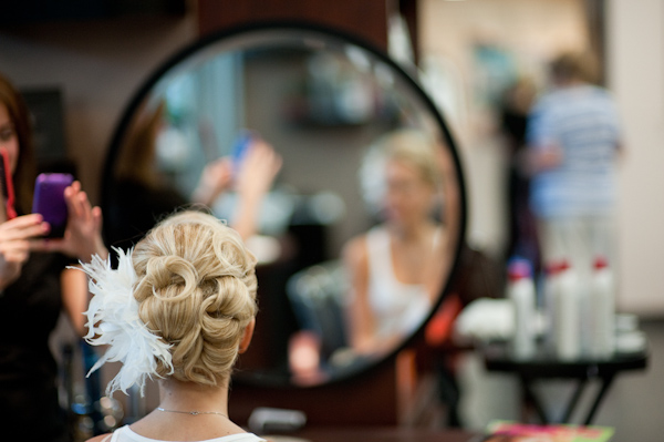 bridal hairstyle with white feather hairpiece - photo by New York based wedding photographers Maloman Photographers
